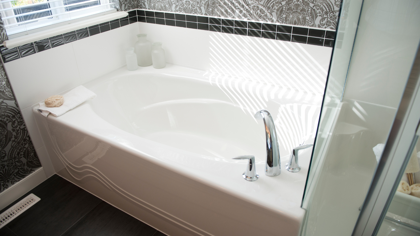 A white bath tub sitting next to a window