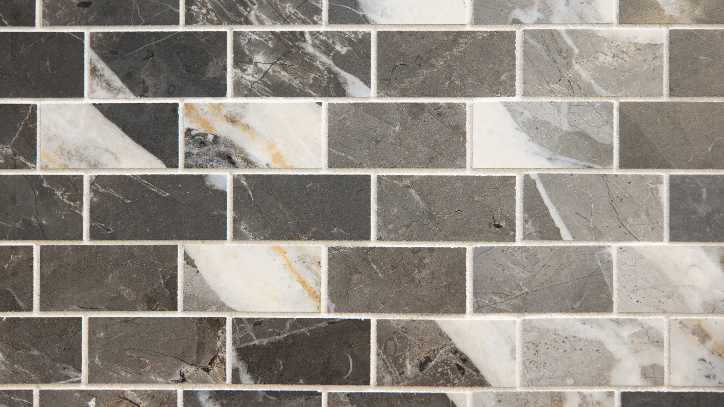 A close up of a tile wall with a black and white pattern