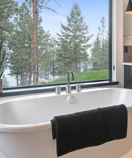 A white bath tub sitting next to a window