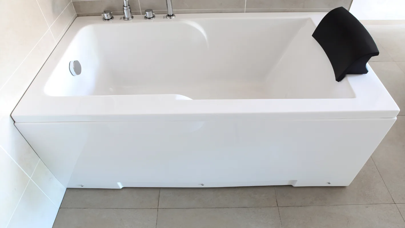 White bathtub beside a shower head
