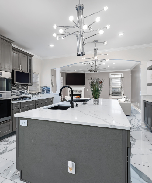 Bright kitchen with white cabinets and marble countertops
