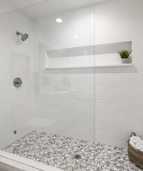 White bathroom with a glass shower door