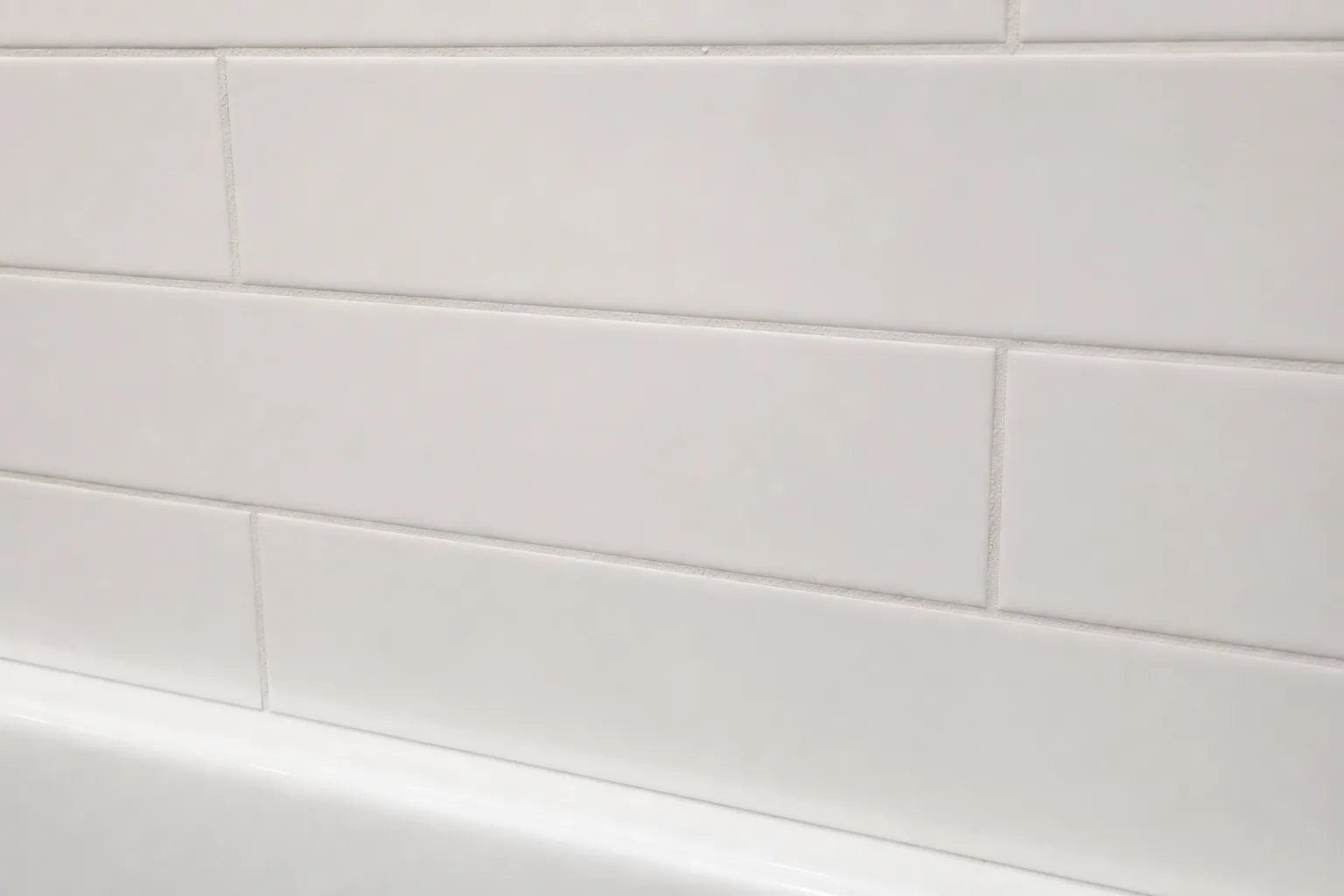 Clean white ceramic tile surround